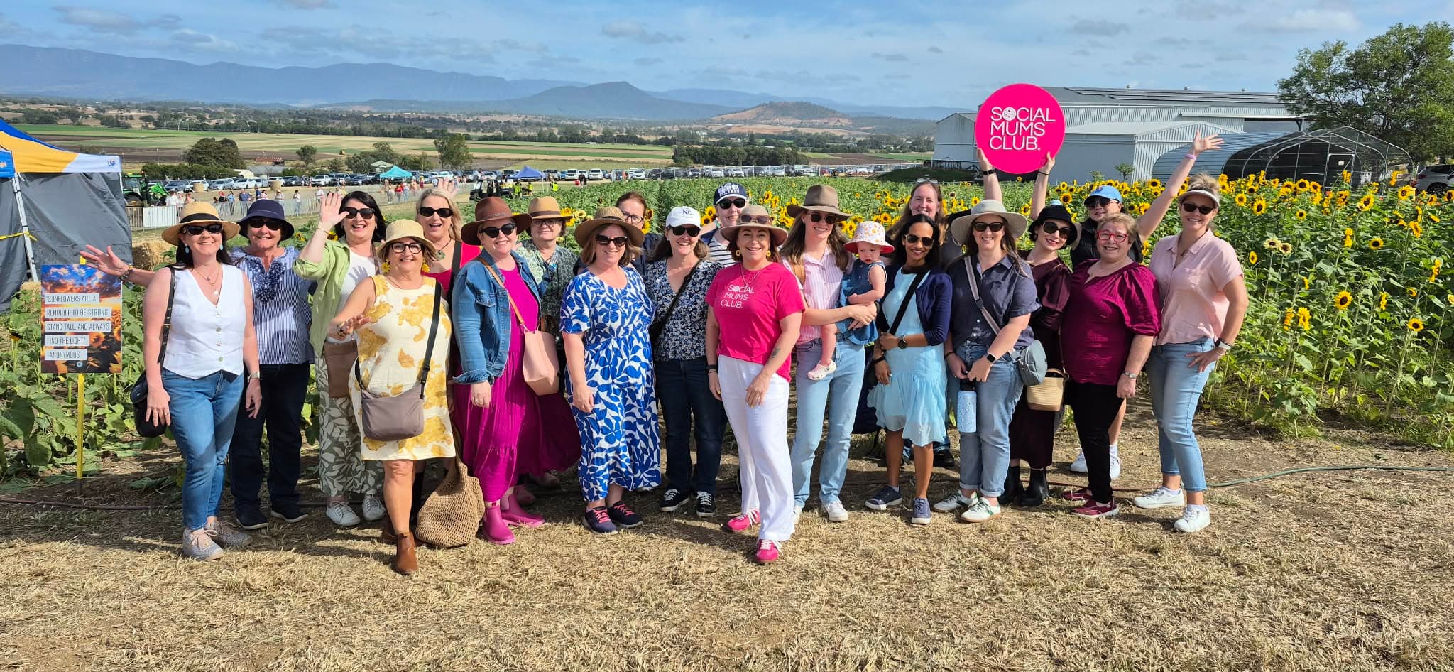 Mums celebrating at a Social Mums Club event in a sunflower field