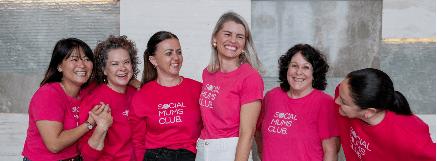 Social Mums Club Gold Coast gals in pink shirts laughing together